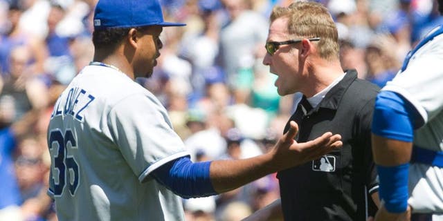 Kansas City Royals starting pitcher Edinson Volquez is given a warning by home plate umpire Jim Wolf after brushing Toronto Blue Jays' Josh Donaldson back with a pitch during the third inning of a baseball game against the Kansas City Royals in Toronto, Sunday Aug. 2, 2015. (Fred Thornhill/The Canadian Press via AP)