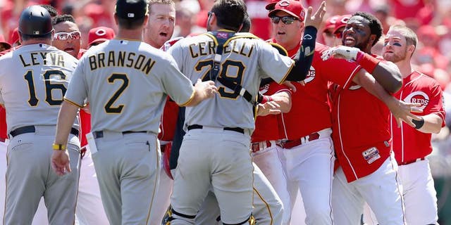 CINCINNATI, OH - AUGUST 02: Brandon Phillips #4 (far right) of the Cincinnati Reds is restrained by Manager Bryan Price after being hit by a pitch in the 8th inning against the Pittsburgh Pirates and benches emptied at Great American Ball Park on August 2, 2015 in Cincinnati, Ohio. (Photo by Andy Lyons/Getty Images)