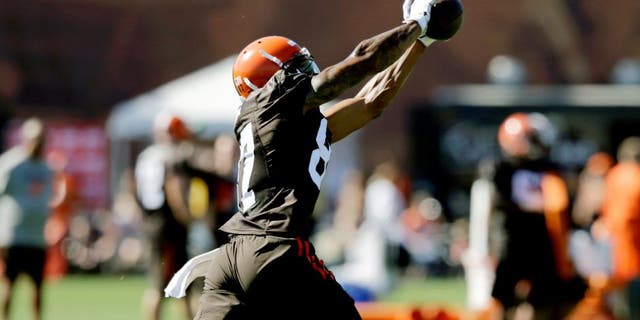Cleveland Browns wide receiver Terrelle Pryor catches a pass during practice at the NFL football team's training camp Thursday, July 30, 2015, in Berea, Ohio. Pryor has been a quarterback his entire football life, but the gifted athlete is swtiching positions at the highest level, trying to win a roster spot as a wide receiver for the Cleveland Browns. He's impressive in pads, but the Browns need him to do more than look good in his uniform. (AP Photo/Tony Dejak)