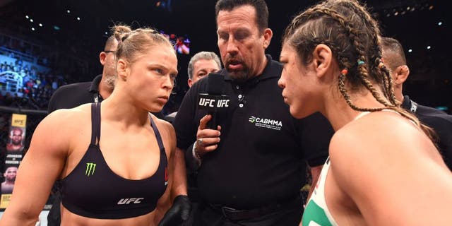 RIO DE JANEIRO, BRAZIL - AUGUST 01: UFC strawweight champion Ronda Rousey of the United States Bethe Correia of Brazil face off in their UFC women's bantamweight championship bout during the UFC 190 event inside HSBC Arena on August 1, 2015 in Rio de Janeiro, Brazil. (Photo by Josh Hedges/Zuffa LLC/Zuffa LLC via Getty Images)