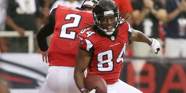 Sep 7, 2014; Atlanta, GA, USA; Atlanta Falcons wide receiver Roddy White (84) celebrates his touchdown with Atlanta Falcons quarterback Matt Ryan (2) in the first half of their game against the New Orleans Saints at the Georgia Dome. The Falcons won 37-34 in overtime. Mandatory Credit: Jason Getz-USA TODAY Sports