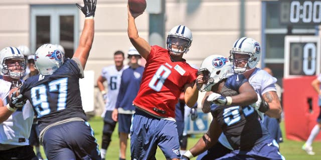 Jul 31, 2015; Nashville, TN, USA; Tennessee Titans quarterback Marcus Mariota (8) passes against Titans defensive lineman Karl Klug (97) during his first day of training camp at Saint Thomas Sports Park. Mandatory Credit: Jim Brown-USA TODAY Sports