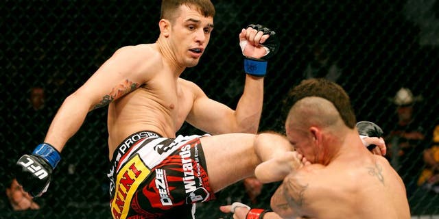DALLAS, TX - MARCH 15: (L-R) Myles Jury kicks Diego Sanchez in their lightweight bout at UFC 171 inside American Airlines Center on March 15, 2014 in Dallas, Texas. (Photo by Josh Hedges/Zuffa LLC/Zuffa LLC via Getty Images)