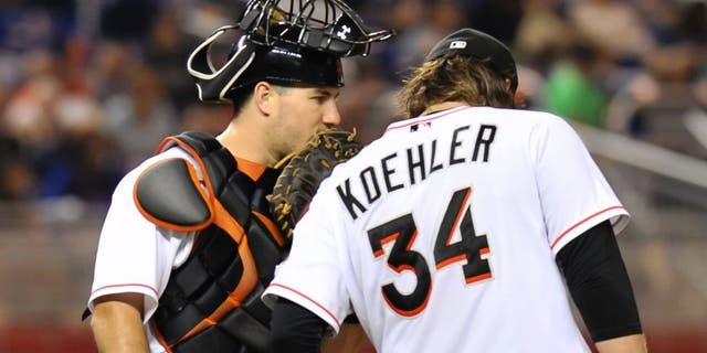 Aug 3, 2015; Miami, FL, USA; Miami Marlins catcher J.T. Realmuto (left) talks with starting pitcher Tom Koehler (right) on the pitchers mound during the fourth inning against the New York Mets at Marlins Park. Mandatory Credit: Steve Mitchell-USA TODAY Sports