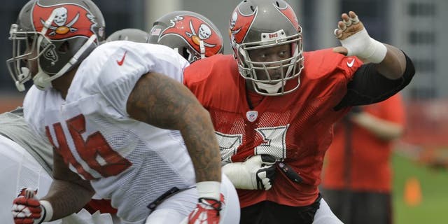 Tampa Bay Buccaneers defensive tackle Gerald McCoy, right, pressures the offense during a Buccaneers NFL football training camp practice Monday, Aug. 3, 2015, in Tampa, Fla. (AP Photo/Chris O'Meara)