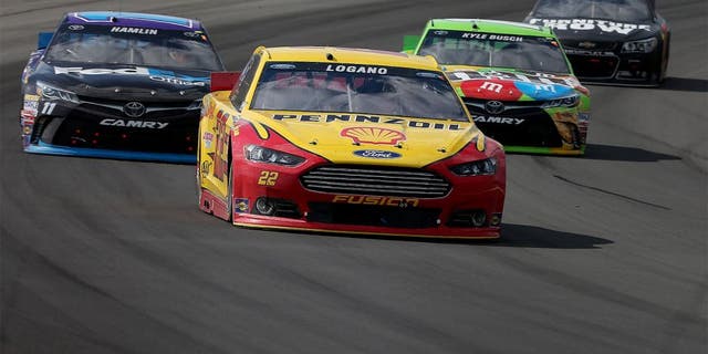 LONG POND, PA - AUGUST 02: Joey Logano, driver of the #22 Shell Pennzoil Ford, leads a pack of cars during the NASCAR Sprint Cup Series Windows 10 400 at Pocono Raceway on August 2, 2015 in Long Pond, Pennsylvania. (Photo by Nick Laham/Getty Images)
