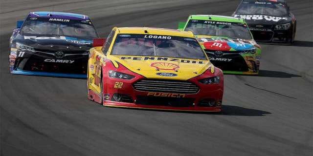 LONG POND, PA - AUGUST 02: Joey Logano, driver of the #22 Shell Pennzoil Ford, leads a pack of cars during the NASCAR Sprint Cup Series Windows 10 400 at Pocono Raceway on August 2, 2015 in Long Pond, Pennsylvania. (Photo by Nick Laham/Getty Images)