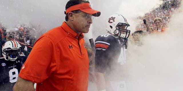 Aug 31, 2013; Auburn, AL, USA; Auburn Tigers head coach Gus Malzahn and his team enter the field at Jordan Hare Stadium for the game against the Washington State Cougars. The Tigers beat the Cougars 31-24. Mandatory Credit: John Reed-USA TODAY Sports