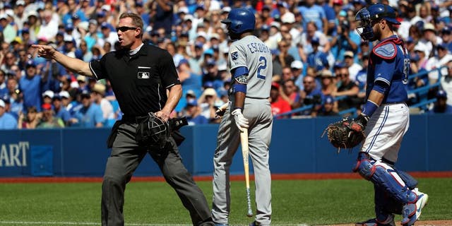 Toronto, Canada - August 2 - Umpire Jim Wolf (28) calls out Toronto Blue Jays starting pitcher Aaron Sanchez (41) for hitting Kansas City Royals shortstop Alcides Escobar (2) with a pitch during MLB action at the Rogers Centre in Toronto on August 2, 2015. (Cole Burston/Toronto Star via Getty Images)