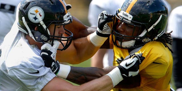 Pittsburgh Steelers tight end Jesse James, left, and linebacker Bud Dupree battle during practice at NFL football training camp in Latrobe, Pa. on Saturday, Aug. 1, 2015 . (AP Photo/Keith Srakocic)