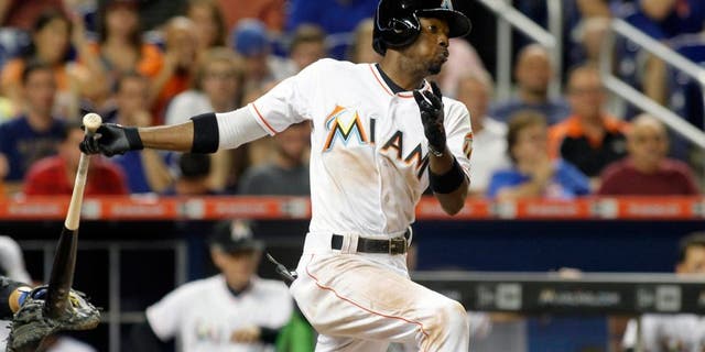 Miami Marlins' Dee Gordon hits an RBI single in the third inning of play against the New York Mets during a baseball game in Miami, Tuesday Aug. 4, 2015. (AP Photo/Joe Skipper)