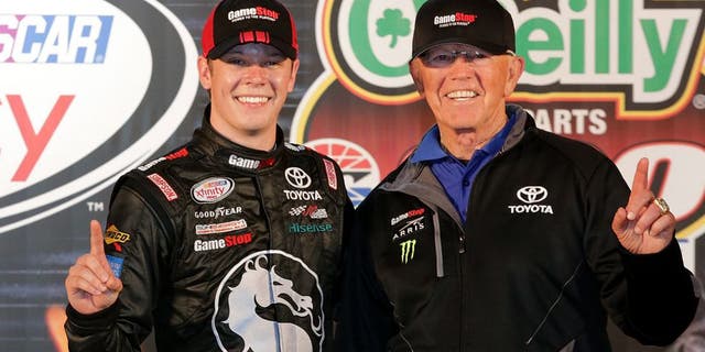 FORT WORTH, TX - APRIL 10: Erik Jones, driver of the #20 GameStop/Mortal Kombat X Toyota, and team owner Joe Gibbs pose with the trophy in Victory Lane after winning the NASCAR XFINITY Series O'Reilly Auto Parts 300 at Texas Motor Speedway on April 10, 2015 in Fort Worth, Texas. (Photo by Jerry Markland/Getty Images for Texas Motor Speedway)