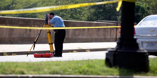 Aug. 4, 2015: Members of the U.S. Park Police investigates the site of a reported shooting near the National Mall in Washington.