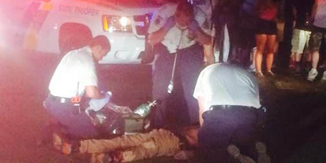 Aug . 3, 2015: Authorities attend to people following a shooting in Holmdel, N.J.