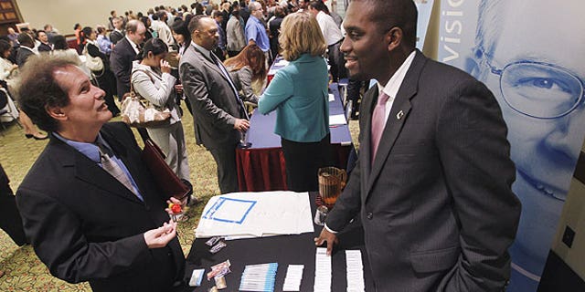 Aug. 4: Recruiter Jason Bryant, right, speaks with job seeker Brian Shumate at the Career Job Fair in Arlington, Va.