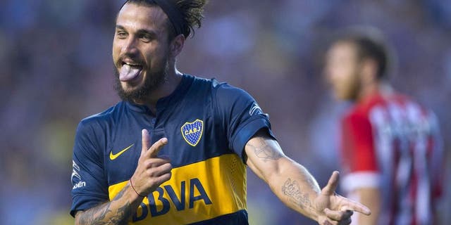 Boca Juniors' forward Daniel Osvaldo (L) celebrates after scoring the team's second goal against Estudiantes during their Argentina First Division football match at La Bombonera stadium in Buenos Aires, Argentina, on March 29, 2015. AFP PHOTO / ALEJANDRO PAGNI (Photo credit should read ALEJANDRO PAGNI/AFP/Getty Images)