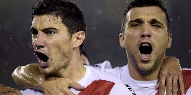 Argentina's River Plate Lucas Alario (L) celebrates with Nicolas Bertolo after scoring against Mexico's Tigres during their Libertadores Cup second leg final match at Americo Vespucio stadium, in Buenos Aires, on August 5, 2015. AFP PHOTO/JUAN MABROMATA (Photo credit should read JUAN MABROMATA/AFP/Getty Images)