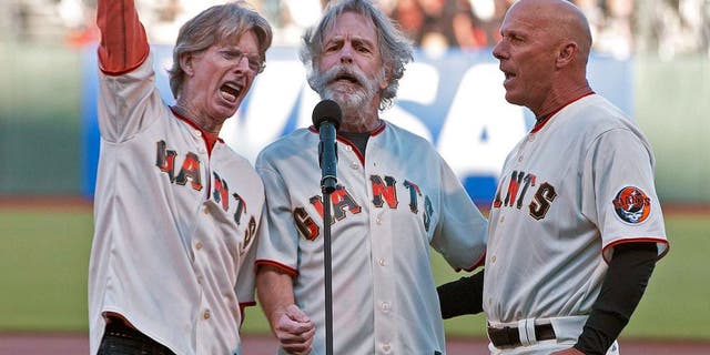 August 9, 2011; San Francisco, CA, USA; Grateful Dead band members Phil Lesh (left) and Bob Weir (center) sing the national anthem with San Francisco Giants third base coach Tim Flannery (right) before the game against the Pittsburgh Pirates at AT&T Park. Mandatory Credit: Jason O. Watson-USA TODAY Sports
