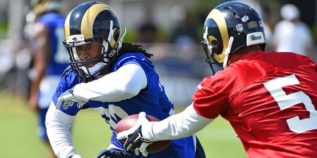 Aug 1, 2015; Earth City, MO, USA; St. Louis Rams quarterback Nick Foles (5) hands the ball to running back Todd Gurley (30) at Rams Park. Mandatory Credit: Jasen Vinlove-USA TODAY Sports