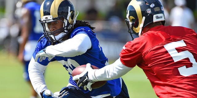 Aug 1, 2015; Earth City, MO, USA; St. Louis Rams quarterback Nick Foles (5) hands the ball to running back Todd Gurley (30) at Rams Park. Mandatory Credit: Jasen Vinlove-USA TODAY Sports