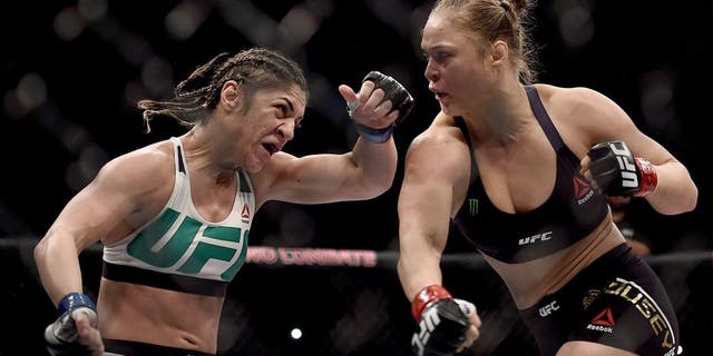 RIO DE JANEIRO, BRAZIL - AUGUST 01: Ronda Rousey of the United States punches Bethe Correia of Brazil in their bantamweight title fight during the UFC 190 Rousey v Correia at HSBC Arena on August 1, 2015 in Rio de Janeiro, Brazil. (Photo by Buda Mendes/Zuffa LLC/Zuffa LLC via Getty Images)