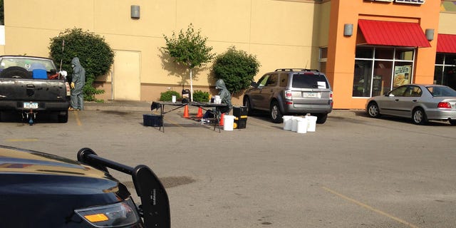 Tuesday, Aug. 4, 2015: Emergency responders examine hazardous materials in the parking lot of a Cedar Rapids Taco Bell where the remnants of a meth lab were found.