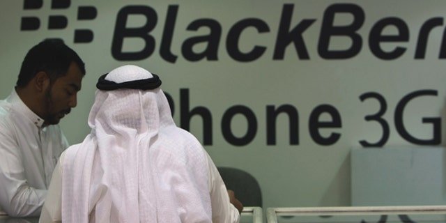 Aug. 5: A Saudi customer is served in a mobile shop at a market in the capital Riyadh, Saudi Arabia. Some Saudis tried to sell their BlackBerrys ahead of an anticipated ban on the smart phone's messenger service