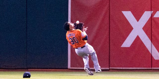 Aug 6, 2015; Oakland, CA, USA; Houston Astros center fielder Carlos Gomez (30) makes an over the shoulder catch against the Oakland Athletics during the fifth inning at O.co Coliseum. Mandatory Credit: Ed Szczepanski-USA TODAY Sports