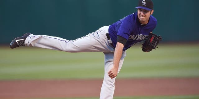 OAKLAND, CA - JUNE 29: David Hale #61 of the Colorado Rockies pitches against the Oakland Athletics in the bottom of the first inning at O.co Coliseum on June 29, 2015 in Oakland, California. (Photo by Thearon W. Henderson/Getty Images)