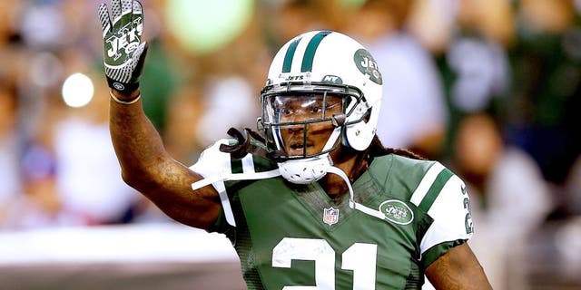 EAST RUTHERFORD, NJ - AUGUST 07: Running back Chris Johnson #21 of the New York Jets celebrates a touchdown against the Indianapolis Colts in the second quarter during a preseason game at MetLife Stadium on August 7, 2014 in East Rutherford, New Jersey. (Photo by Elsa/Getty Images)