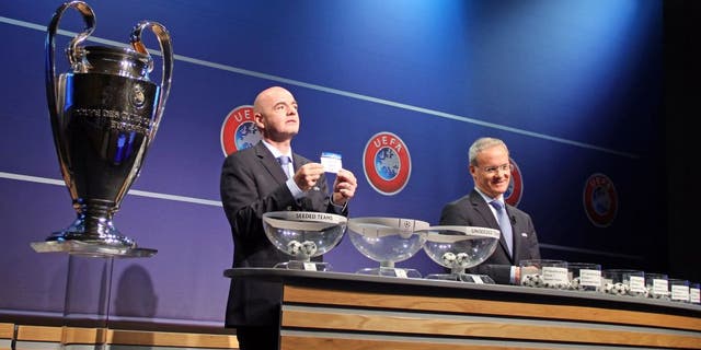NYON, SWITZERLAND - JUNE 22: UEFA General Secretary Gianni Infantino (L) shows the lot of Lincoln Red Imps FC next to UEFA director of competitions Giorgio Marchetti (R) during the draw of the first two qualifying rounds of the UEFA Champions League 2015/16 at the UEFA Headquarters in Nyon, Switzerland on June 22, 2015. (Photo by Fatih Erel/Anadolu Agency/Getty Images)