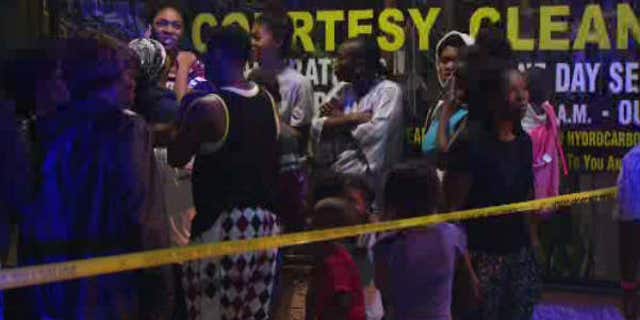 Aug. 7, 2015: In this image made from a video provided by KNBC-TV, relatives of a suspected attacker arrive at the scene after a fatal police shooting in Long Beach, Calif.