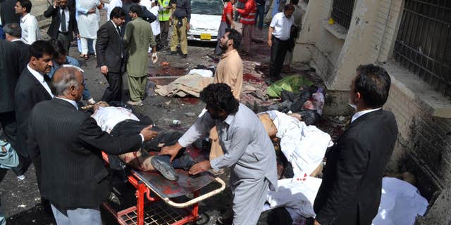 Aug. 8, 2016: People help victims of a bomb blast in Quetta, Pakistan.