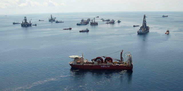 Aug. 3: A support vessel, foreground center, and others surround the Helix Q4000, background center, used to perform the static kill operation, at the site of the Deepwater Horizon Oil Spill in the Gulf of Mexico, off the coast of Louisiana.
