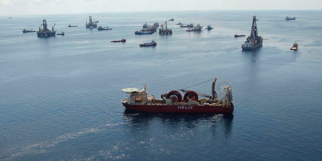 Aug. 3: A support vessel, foreground center, and others surround the Helix Q4000, background center, used to perform the static kill operation, at the site of the Deepwater Horizon Oil Spill in the Gulf of Mexico, off the coast of Louisiana.