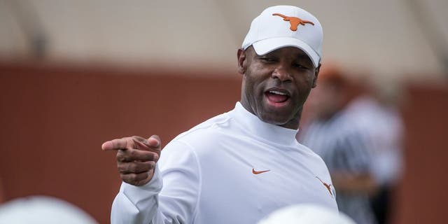 In this Aug. 4, 2014, photo, new University of Texas NCAA college football head coach Charlie Strong watches a morning practice session in Austin, Texas. Strong laid down the law with a series of player dismissals and suspensions, then he moved into the dorm with his team for training camp. (AP Photo/Austin American-Statesman, Ricardo Brazziell ) AUSTIN CHRONICLE OUT, COMMUNITY IMPACT OUT, INTERNET AND TV MUST CREDIT PHOTOGRAPHER AND STATESMAN.COM, MAGS OUT