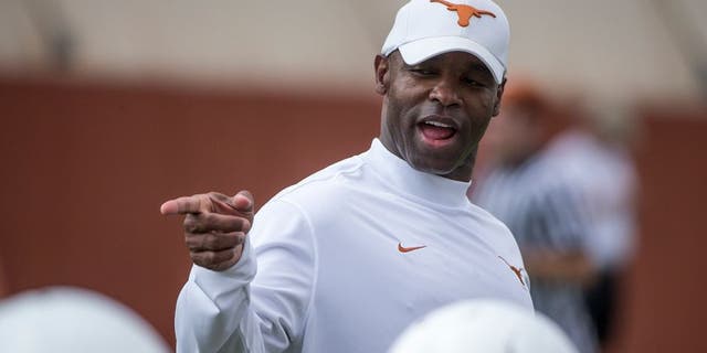 In this Aug. 4, 2014, photo, new University of Texas NCAA college football head coach Charlie Strong watches a morning practice session in Austin, Texas. Strong laid down the law with a series of player dismissals and suspensions, then he moved into the dorm with his team for training camp. (AP Photo/Austin American-Statesman, Ricardo Brazziell ) AUSTIN CHRONICLE OUT, COMMUNITY IMPACT OUT, INTERNET AND TV MUST CREDIT PHOTOGRAPHER AND STATESMAN.COM, MAGS OUT