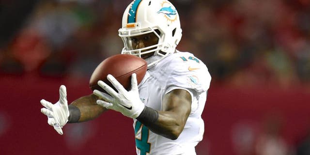 Aug 8, 2014; Atlanta, GA, USA; Miami Dolphins wide receiver Jarvis Landry (14) makes a catch in front of Atlanta Falcons cornerback Javier Arenas (28) during the second quarter at the Georgia Dome. Mandatory Credit: Dale Zanine-USA TODAY Sports