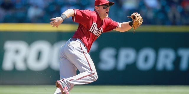 SEATTLE, WA - JULY 29: Shortstop Cliff Pennington #4 of the Arizona Diamondbacks fields a grounder against the Seattle Mariners at Safeco Field on July 29, 2015 in Seattle, Washington. (Photo by Otto Greule Jr/Getty Images)
