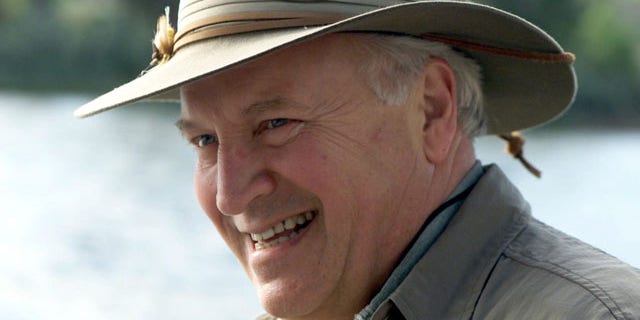 In this July 8, 2001, file photo released by The White House, Vice President Dick Cheney smiles while fly-fishing on the Snake River with his family in his home state of Wyoming.