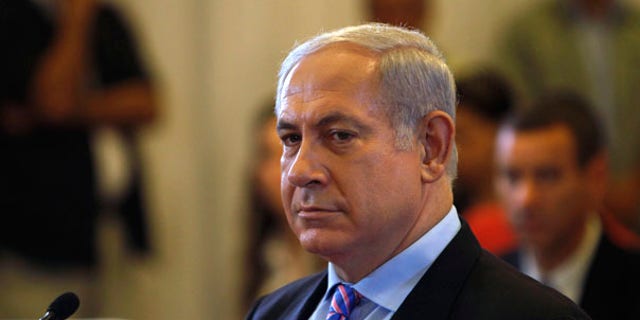 Israel's Prime Minister Benjamin Netanyahu sits before testifying in front of  a state-appointed inquiry commission into the Israeli naval raid on a Gaza aid flotilla, in Jerusalem, Monday, Aug. 9, 2010. Netanyahu testified Monday before his country's inquiry commission into the bloodshed aboard a Turkish ship that tried to break the Gaza blockade in May 2010, defending Israel's actions and suggesting Turkey had been seeking a confrontation. (AP Photo/Ronen Zvulun, Pool)