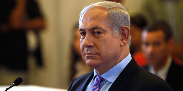 Israel's Prime Minister Benjamin Netanyahu sits before testifying in front of a state-appointed inquiry commission into the Israeli naval raid on a Gaza aid flotilla, in Jerusalem, Monday, Aug. 9, 2010. Netanyahu testified Monday before his country's inquiry commission into the bloodshed aboard a Turkish ship that tried to break the Gaza blockade in May 2010, defending Israel's actions and suggesting Turkey had been seeking a confrontation. (AP Photo/Ronen Zvulun, Pool)