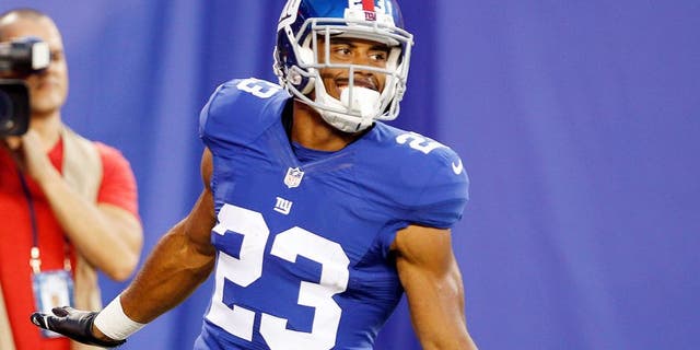 Aug 9, 2014; East Rutherford, USA; New York Giants running back Rashad Jennings (23) celebrates after scoring a touchdown against the Pittsburgh Steelers during the preseason game at MetLife Stadium. Mandatory Credit: William Perlman/THE STAR-LEDGER via USA TODAY Sports