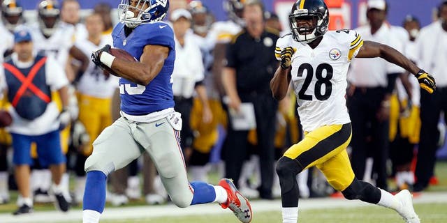 Aug 9, 2014; East Rutherford, USA; New York Giants running back Rashad Jennings (23) scores a touchdown past Pittsburgh Steelers cornerback Cortez Allen (28) during the preseason game at MetLife Stadium. Mandatory Credit: William Perlman/THE STAR-LEDGER via USA TODAY Sports