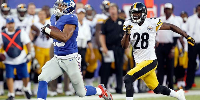 Aug 9, 2014; East Rutherford, USA; New York Giants running back Rashad Jennings (23) scores a touchdown past Pittsburgh Steelers cornerback Cortez Allen (28) during the preseason game at MetLife Stadium. Mandatory Credit: William Perlman/THE STAR-LEDGER via USA TODAY Sports