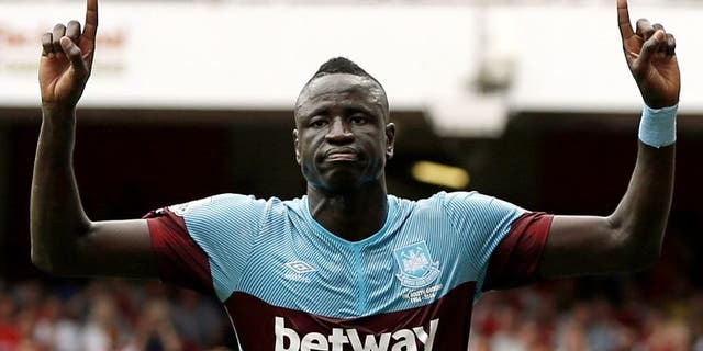 West Ham United's Senegalese midfielder Cheikhou Kouyate celebrates scoring the opening goal of the English Premier League football match between Arsenal and West Ham United at the Emirates Stadium in London on August 9, 2015. AFP PHOTO / ADRIAN DENNIS RESTRICTED TO EDITORIAL USE. No use with unauthorized audio, video, data, fixture lists, club/league logos or 'live' services. Online in-match use limited to 75 images, no video emulation. No use in betting, games or single club/league/player publications. (Photo credit should read ADRIAN DENNIS/AFP/Getty Images)