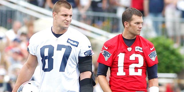 Jul 24, 2014; Foxborough, MA, USA; New England Patriots tight end Rob Gronkowski (87) and quarterback Tom Brady (12) during training camp at the team practice facility. Mandatory Credit: Stew Milne-USA TODAY Sports