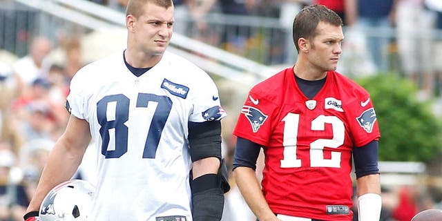 Jul 24, 2014; Foxborough, MA, USA; New England Patriots tight end Rob Gronkowski (87) and quarterback Tom Brady (12) during training camp at the team practice facility. Mandatory Credit: Stew Milne-USA TODAY Sports