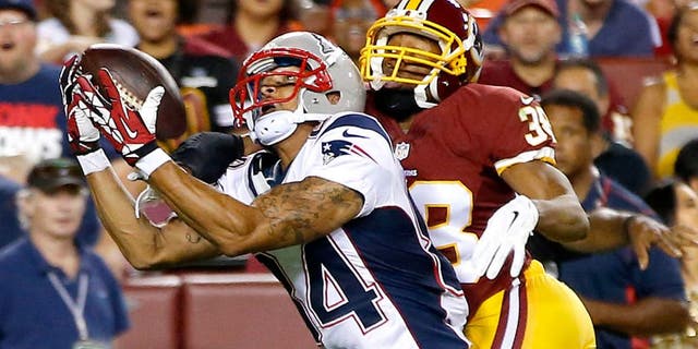 Aug 7, 2014; Landover, MD, USA; New England Patriots wide receiver Brian Tyms attempts to catch the ball as Washington Redskins defensive back Chase Minnifield (38) defends in the third quarter during a preseason game at FedEx Field. The Redskins won 23-6. Mandatory Credit: Geoff Burke-USA TODAY Sports