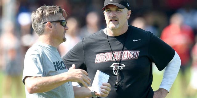 Jul 31, 2015; Flowery Branch, GA, USA; Atlanta Falcons head coach Dan Quinn (right) talks to General Manager Thomas Dimitroff on the field during training camp at Flowery Branch Training Facility. Mandatory Credit: Dale Zanine-USA TODAY Sports